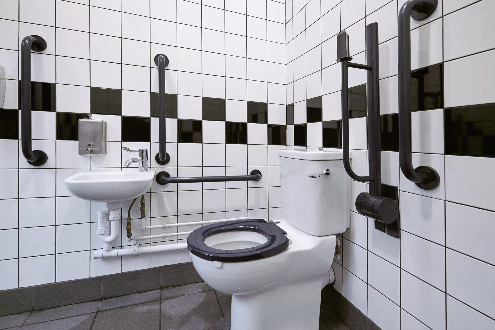disabled doc m toilet at coventry bus station with black and white feature tiling.jpg