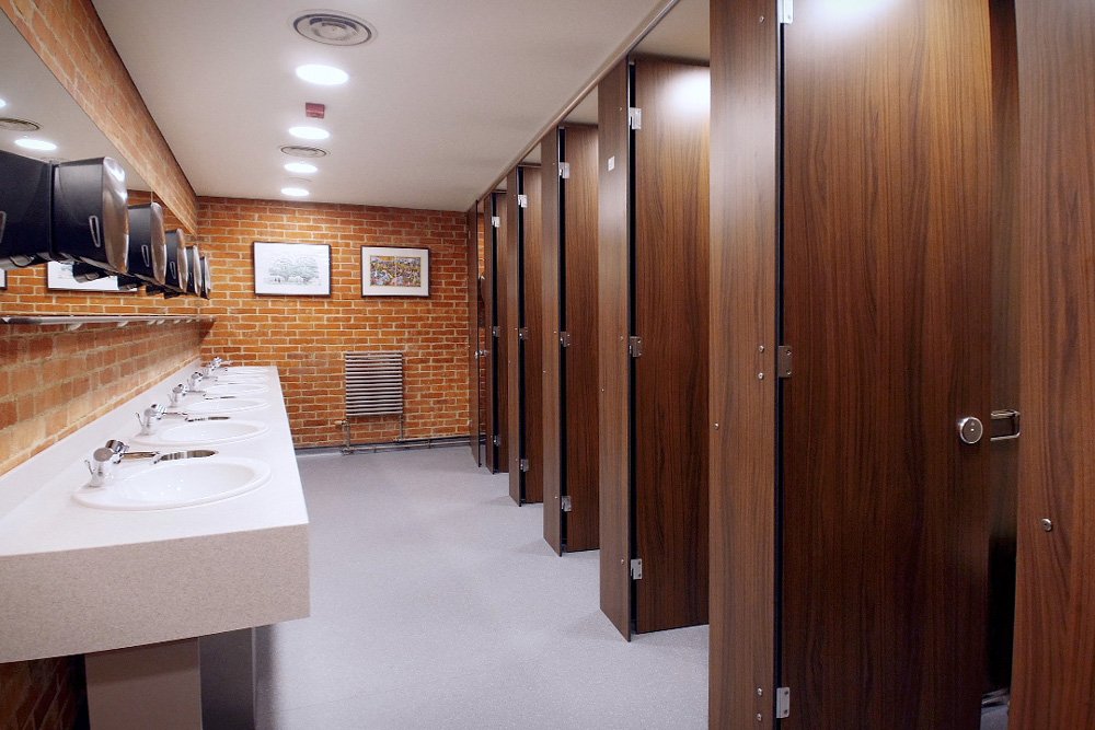 row of toilet cubiles and sinks at glyndebourne opera house.jpg