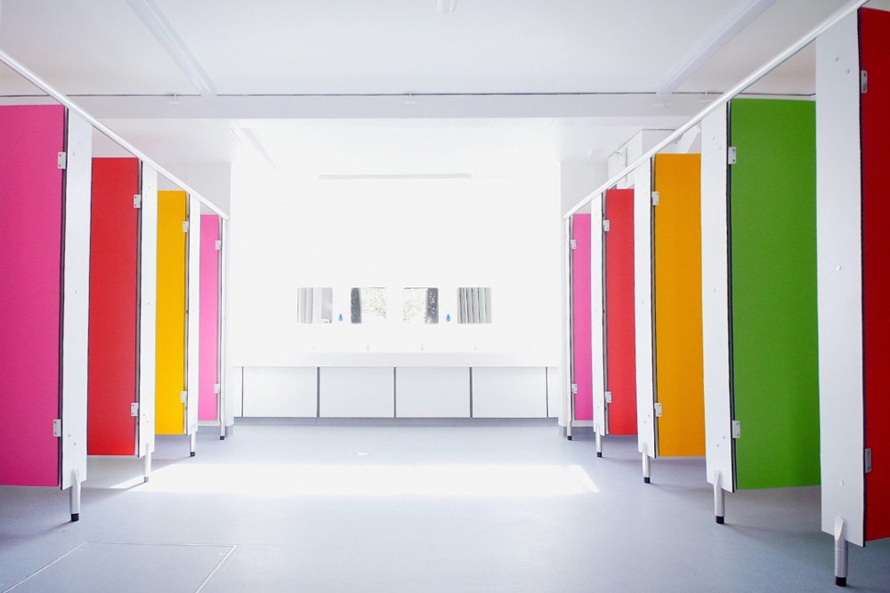washroom with multicoloured cubicle doors at lycee francais.jpg