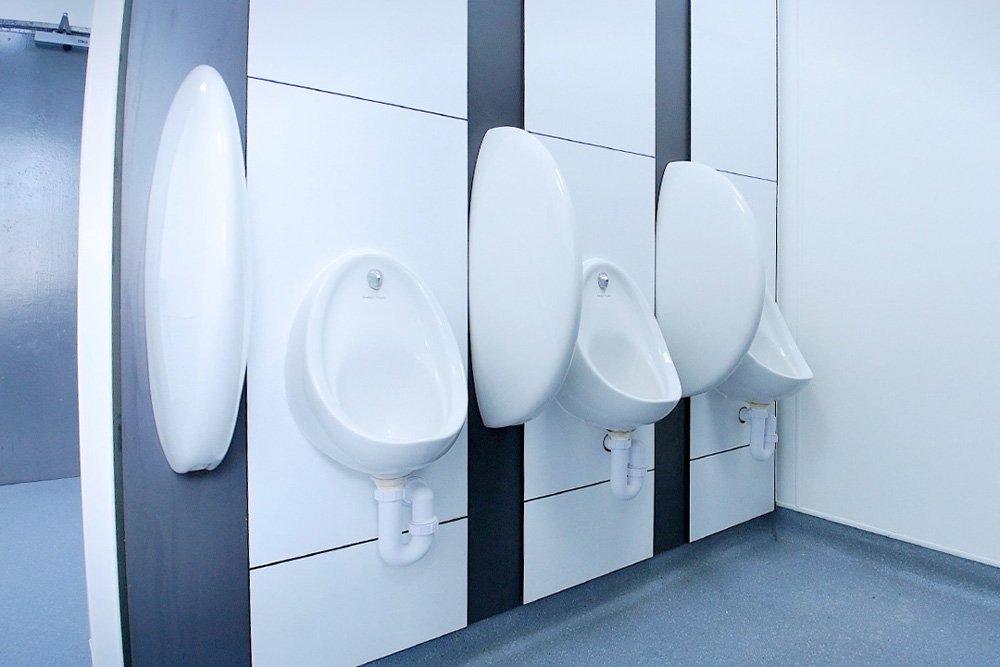 white duct panels with urinals and privacy screens at lycee francais.jpg