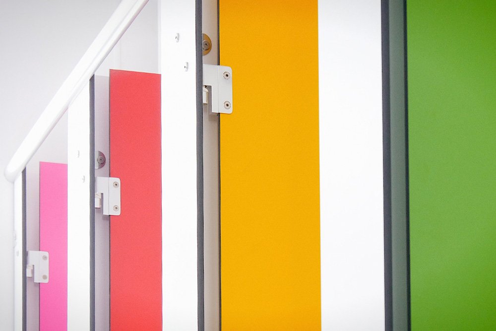 close up of multicoloured cubicle doors at lycee francais.jpg