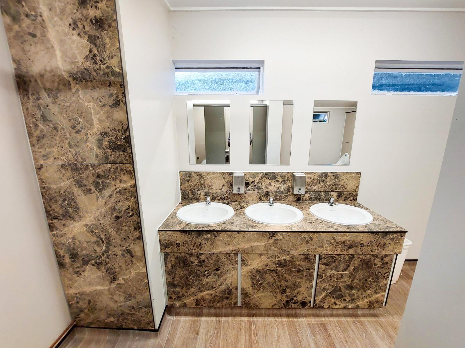 a vanity unit with recessed sinks in a bespoke green marble pattern at howletts zoo.jpg