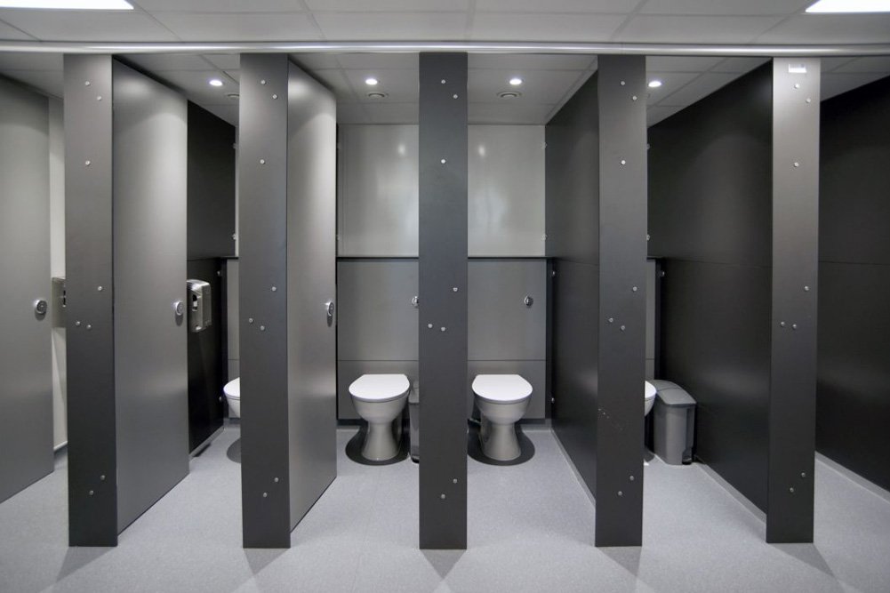 a row of toilet cubicles with grey half height ducts and grey full height privacy doors at princes risborough school.jpg