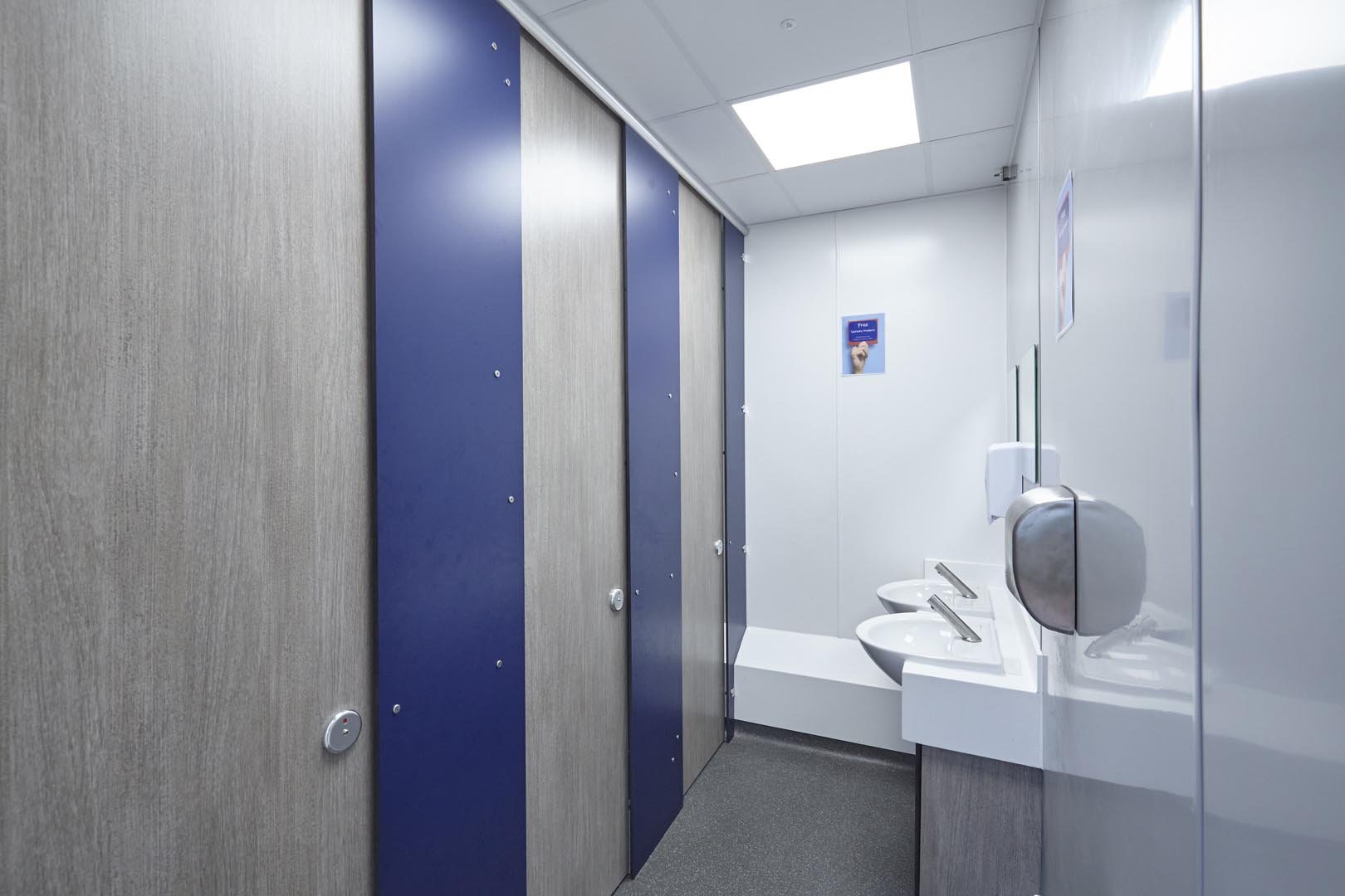 unisex privacy toilet cubicles and vanity unit in grey woodgrain and navy at collingwood.jpg