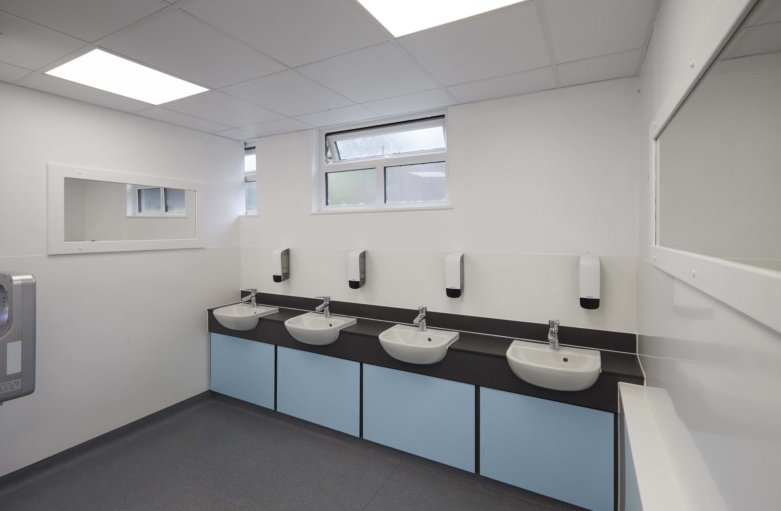 blue vanity unit with sinks and dispensers at box hill school.jpg