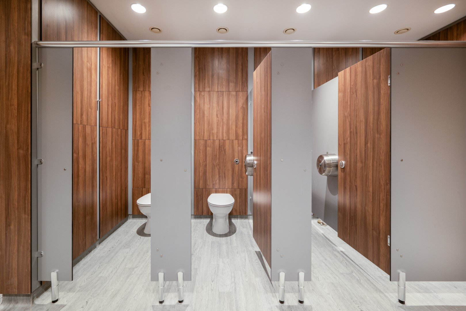  duct panelling and toilet cubicles in a commercial washroom 