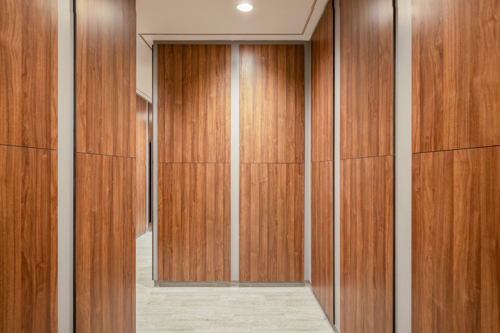  entrance to a commercial washroom with wood effect walls 