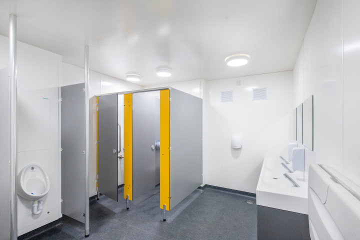 urinal, cubicles and vanity unit with hygipod ips in white, grey and yellow at blyburgate public toilets.png