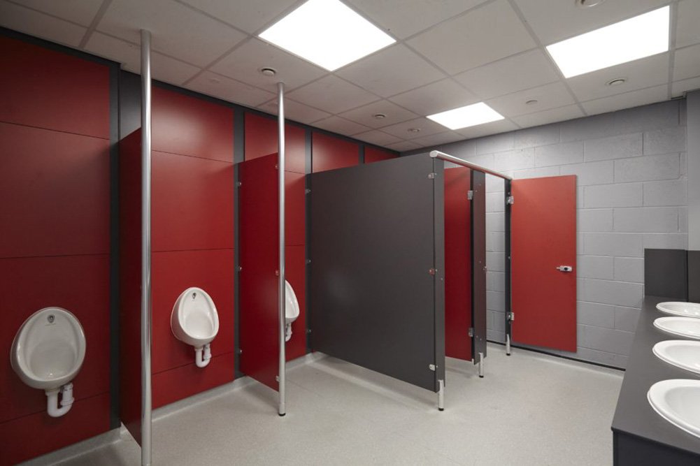 boys toilet at ark acton academy with toilets and urinals and red and grey colour scheme.jpg