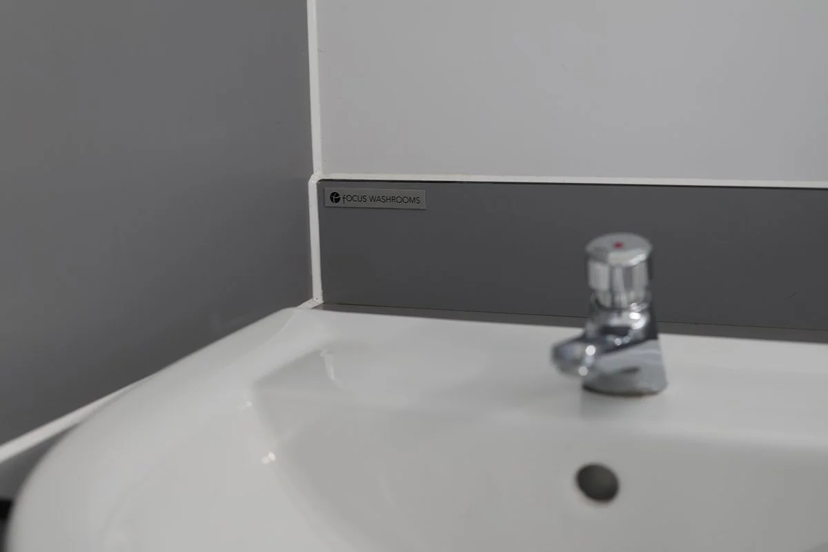 Basin with focus washrooms plaque behind it at Ascot Racecourse.jpg