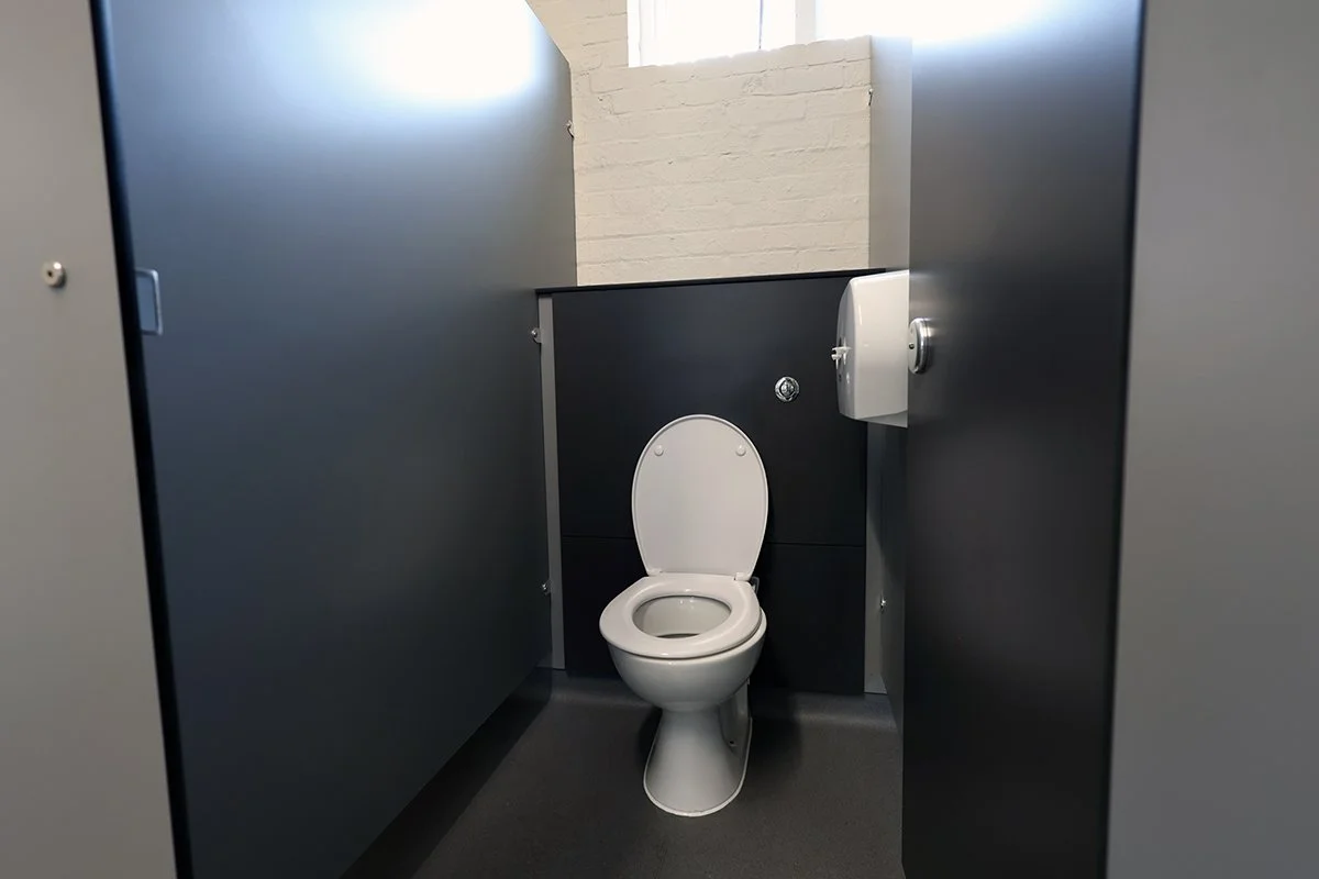 Single toilet cubicle with toilet and push flush at Ascot Racecourse.jpg