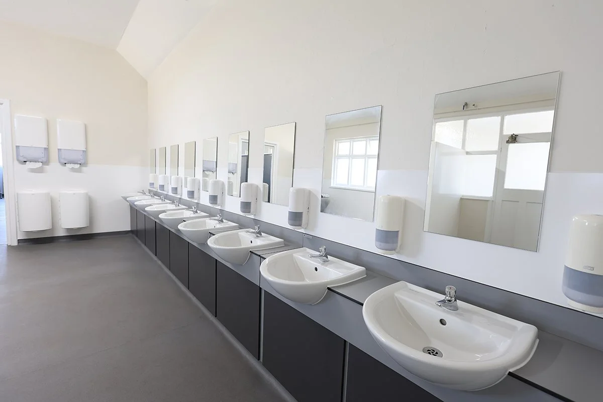 Full suite of wash basins with mirros and paper towel dispensers at Ascot Racecourse.jpg