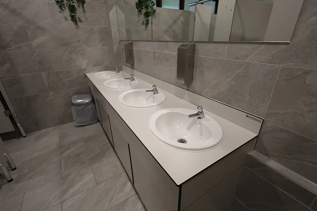 Four fully recessed basins with push taps at golf club.jpg