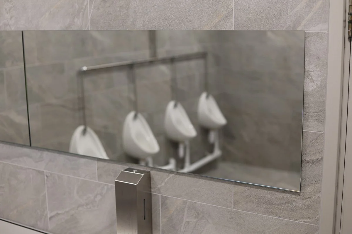 Close up of mirrors in mens washroom at golf club.jpg