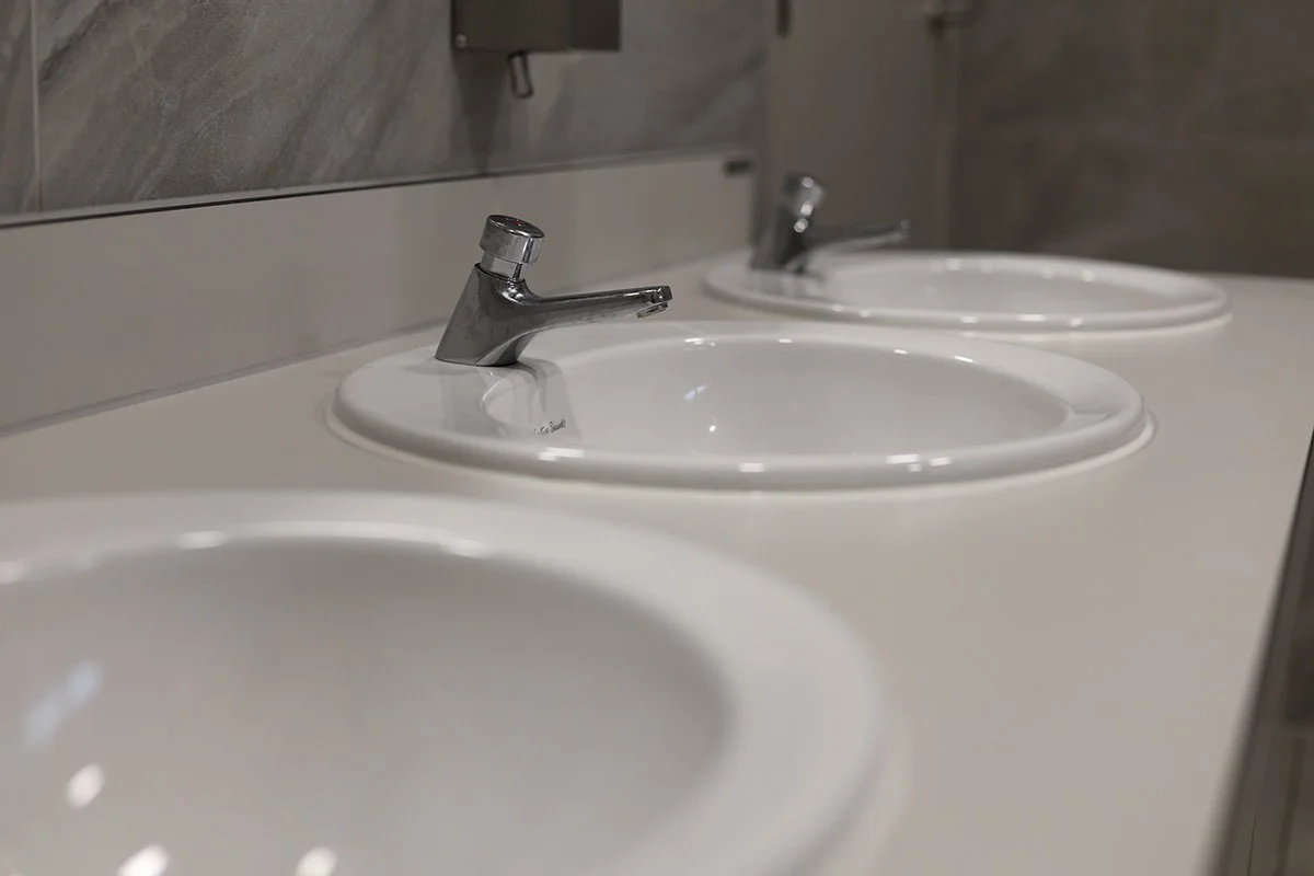 Fully recessed basins with push taps at golf club.jpg