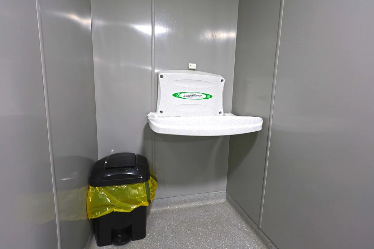 Baby changing unit with sanitary bin at holiday park.jpg