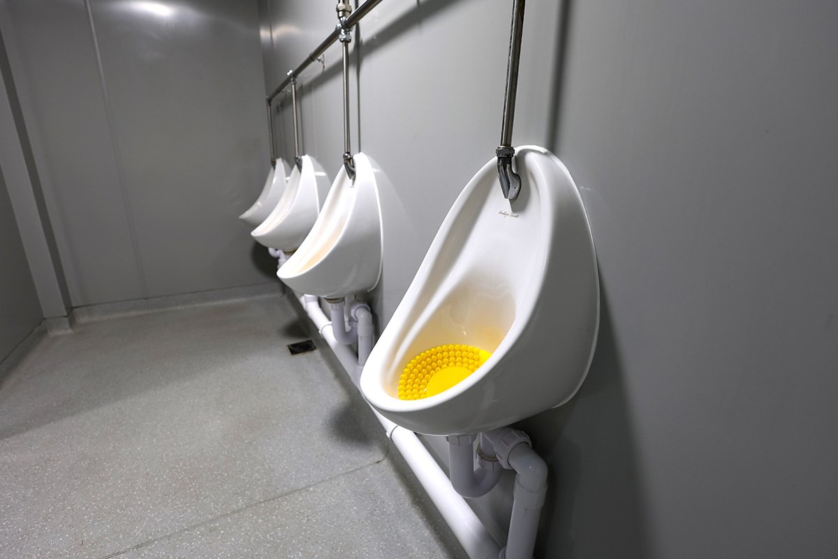 Set of four urinals at holiday park.jpg
