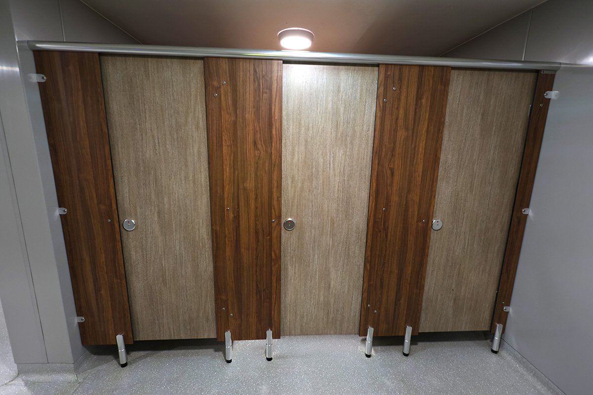 Three closed cubicles with wooden effect at holiday park.jpg