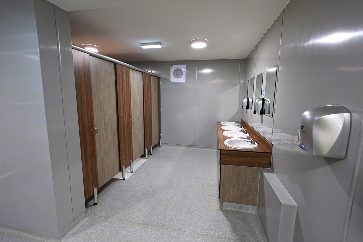 Cubicles and vanity unit with wooden effect at holiday park.jpg