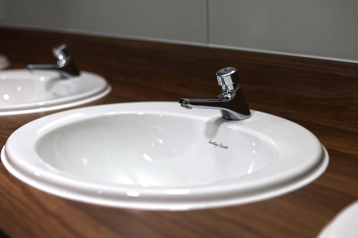 Close up of fully recessed basin with push tap at holiday park.jpg