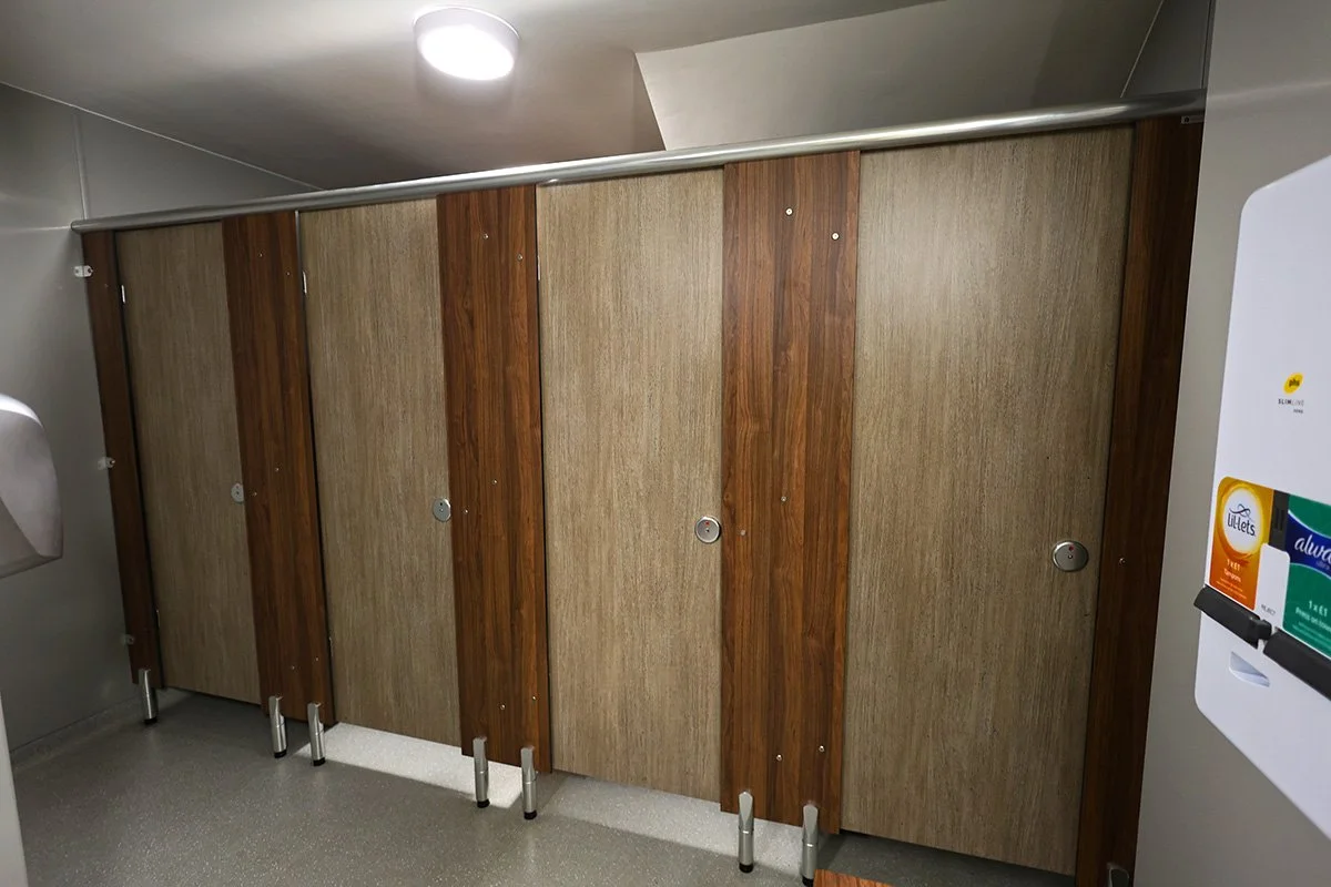 Four closed solid grade laminate cubicles at holiday park.jpg