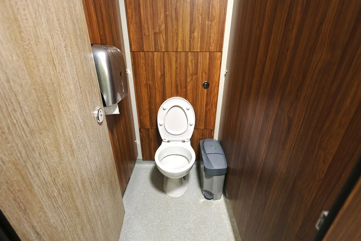 Full cubicle with toilet and push flush at holiday park.jpg