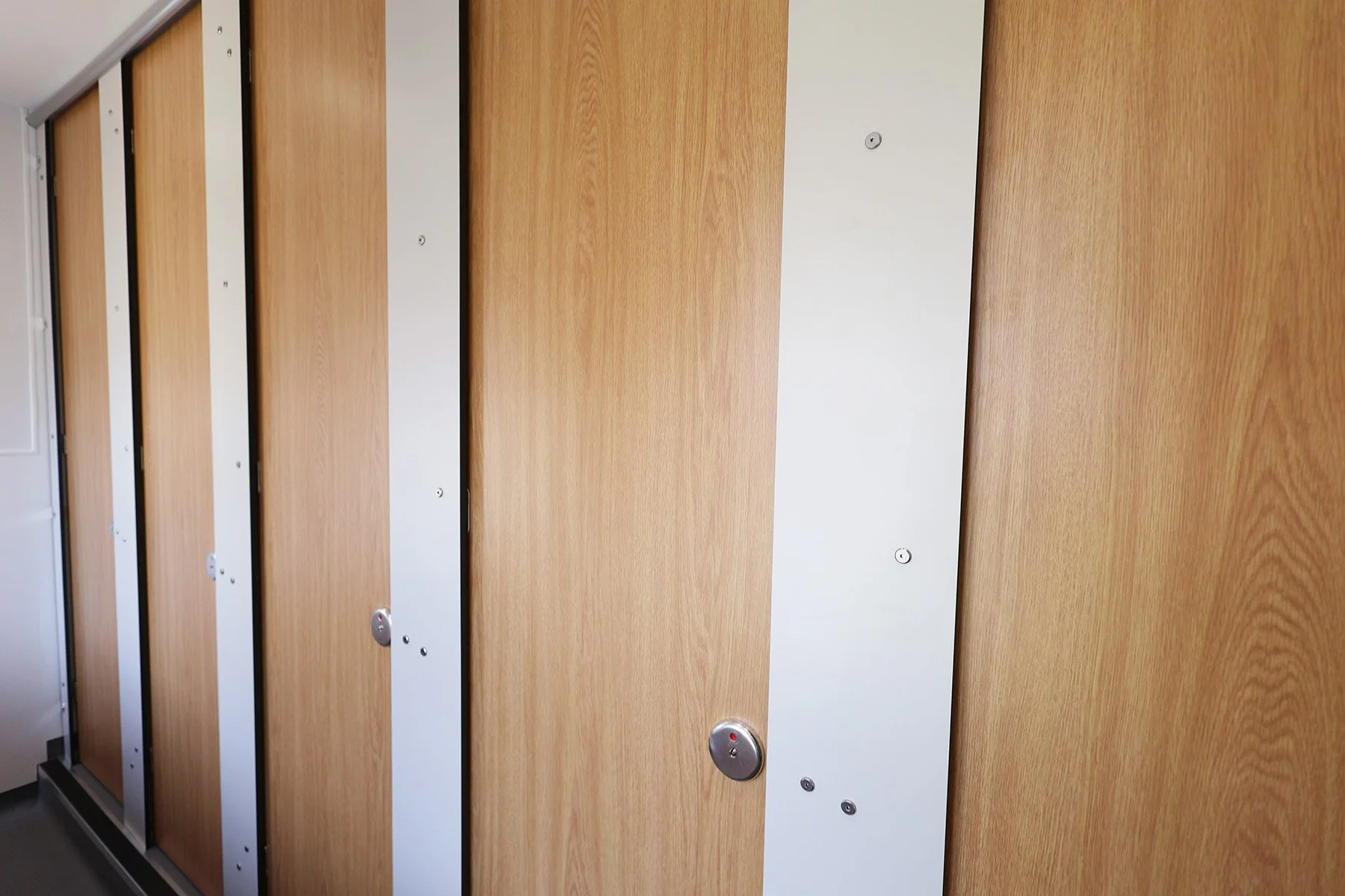 Close full height cubicle doors with wood grain effect at Lancing College.jpg