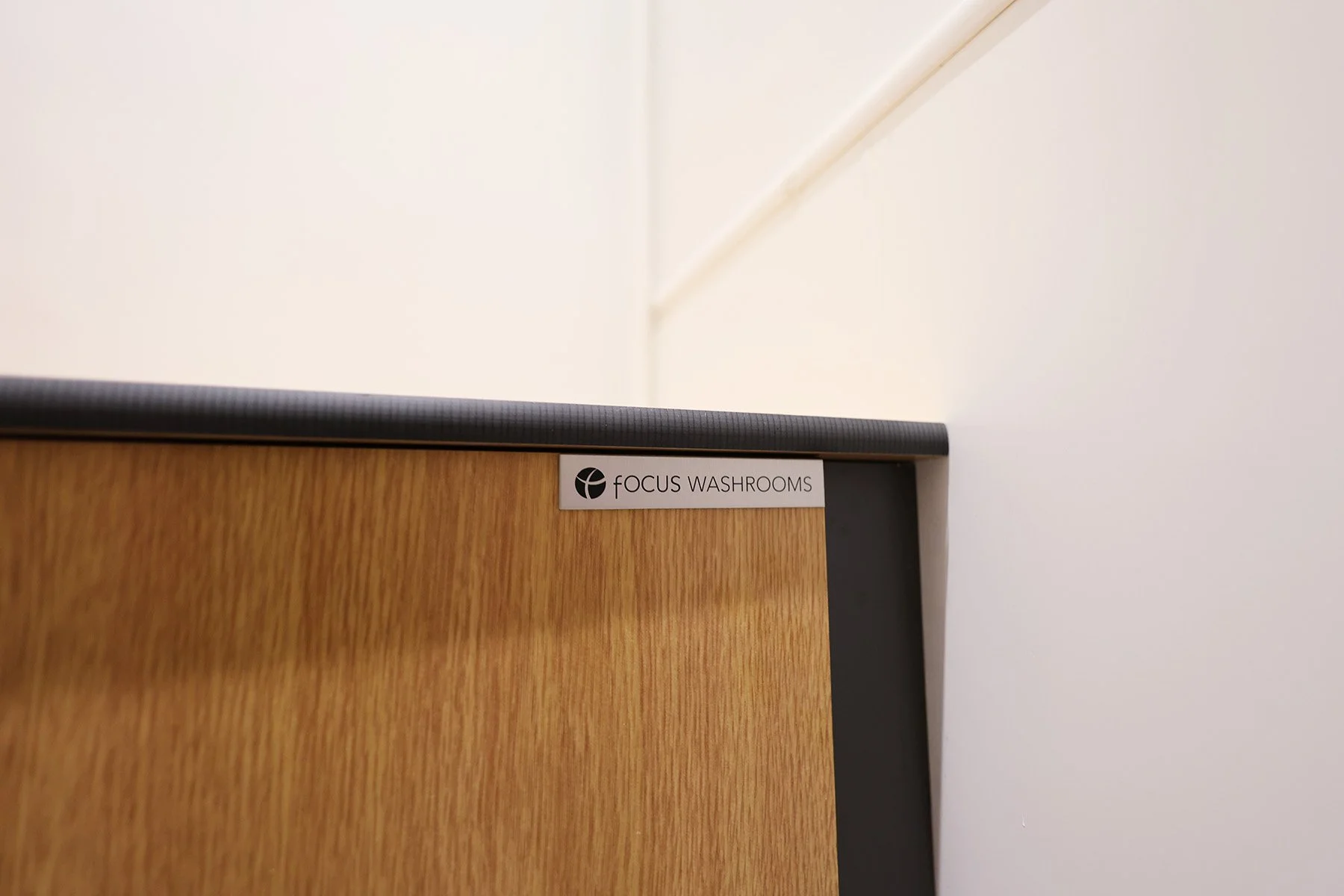 Focus washrooms badge on duct panelling at Lancing College.jpg