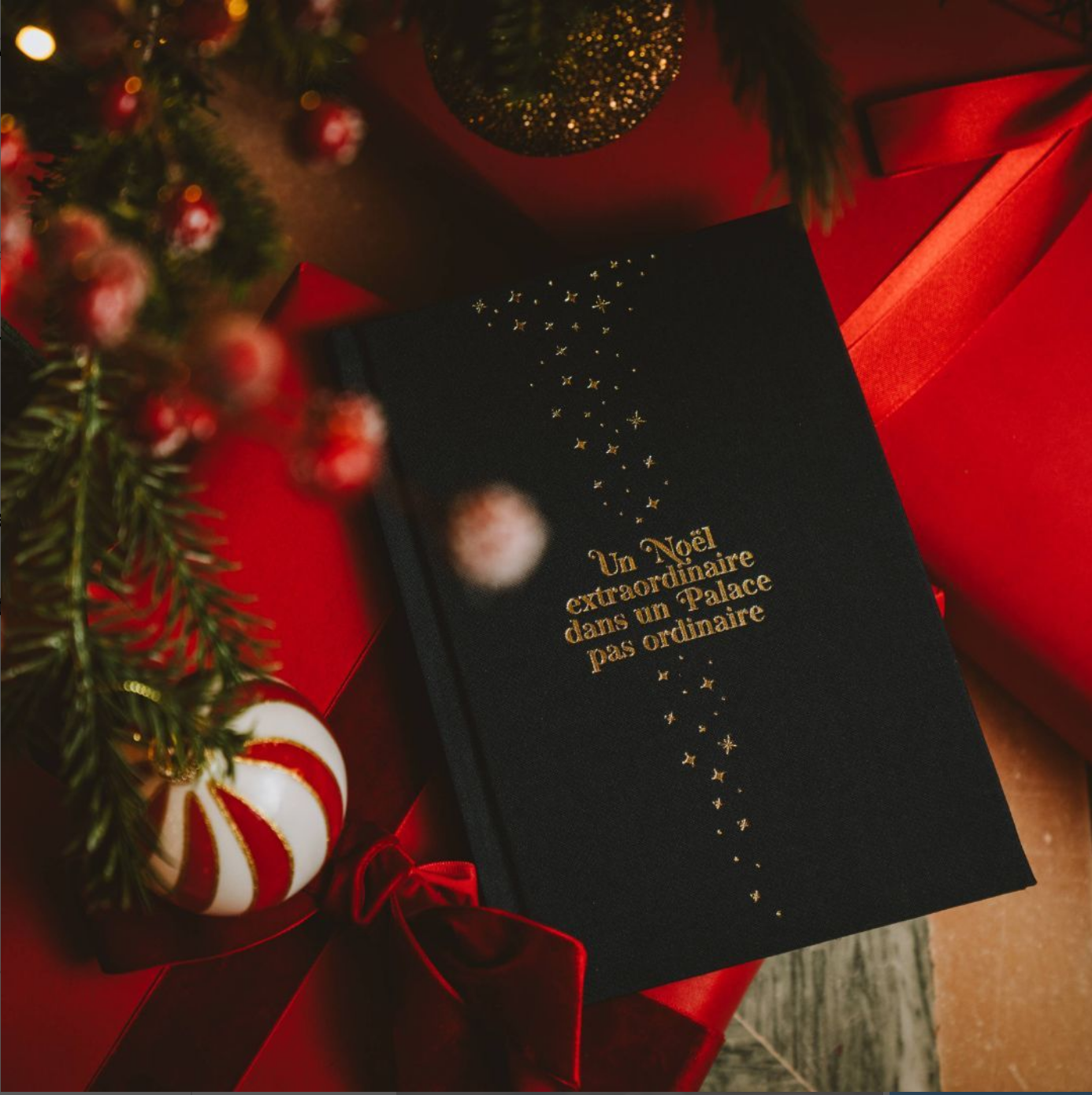 Illustrated Christmas book displayed in a warm and elegant holiday setting, evoking a luxury hotel atmosphere