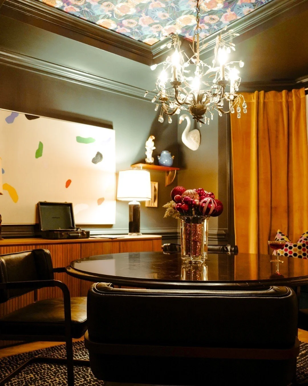 WANDERLUST COMES HOME. I designed this dining room as a tribute to my favorite &ldquo;adult&rdquo; travel destinations: hotel bars I absolutely love. Rich tones and textures, warm lighting, a record player spinning in the background, and holiday touc