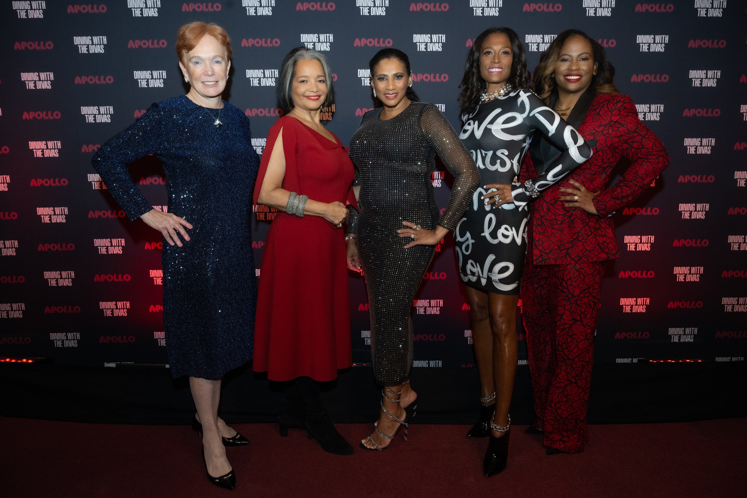 Five women posting of a black background