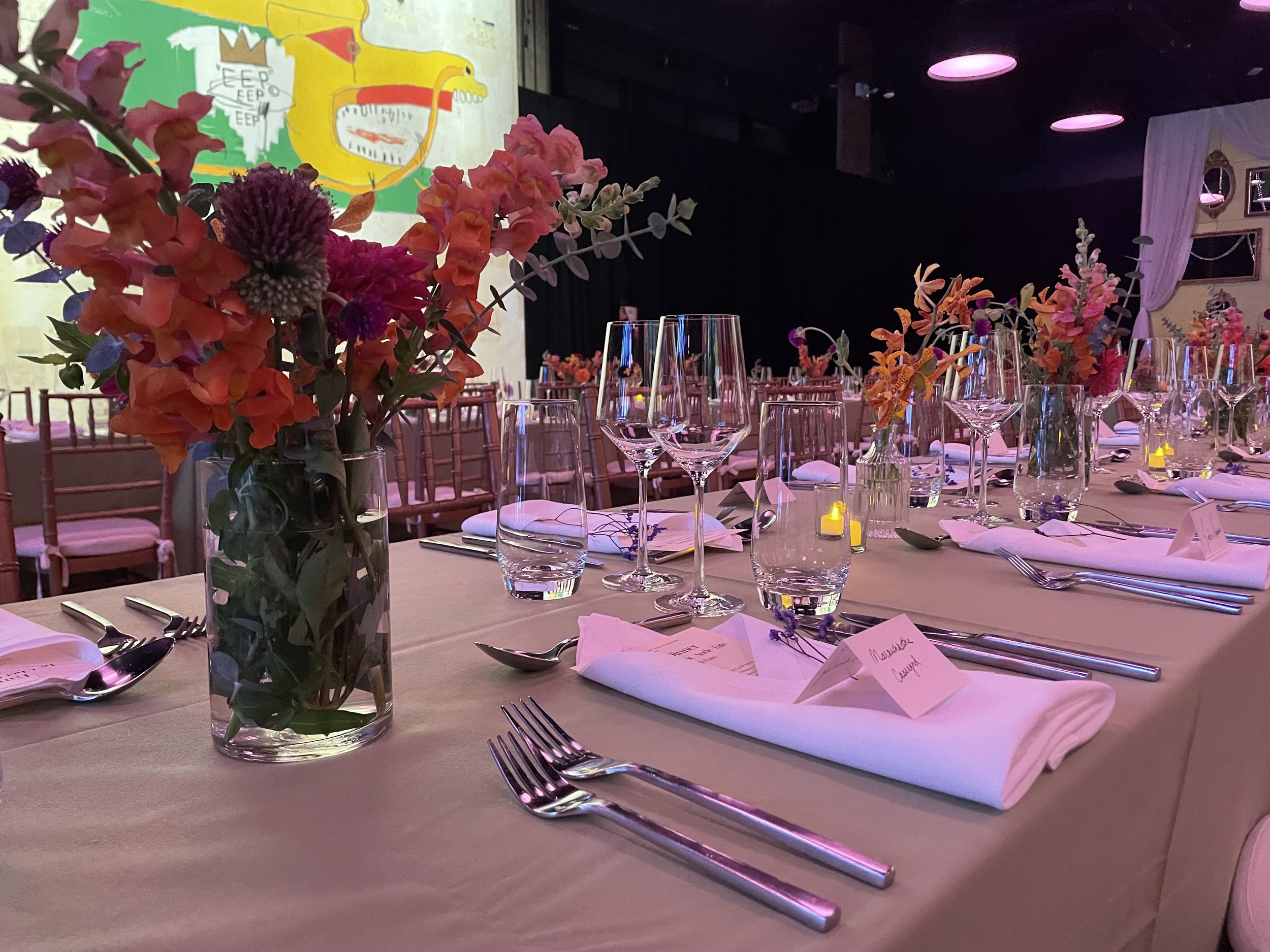 Purple and Pink floral arrangements on a table