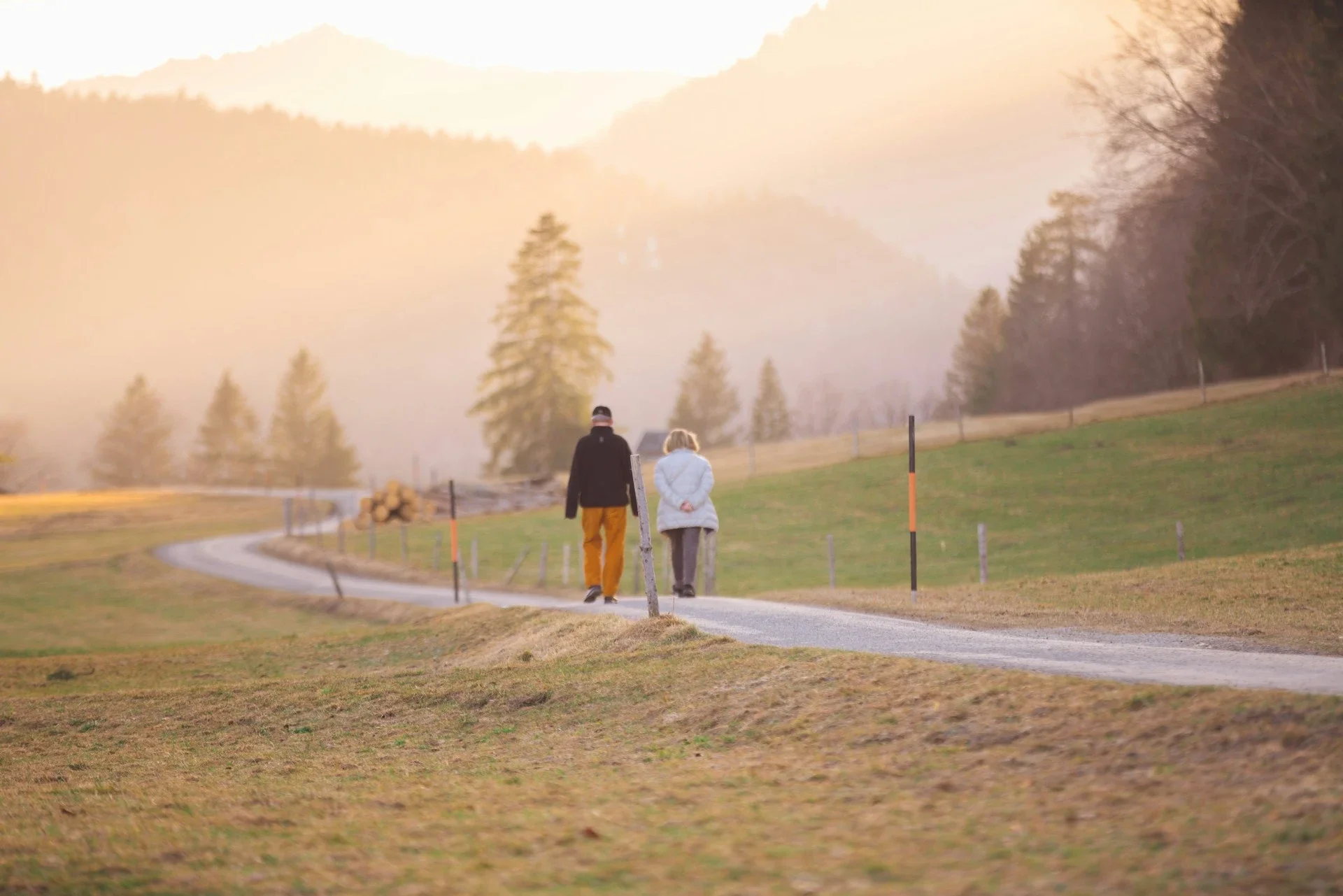 retired man and woman walking on path outdoors