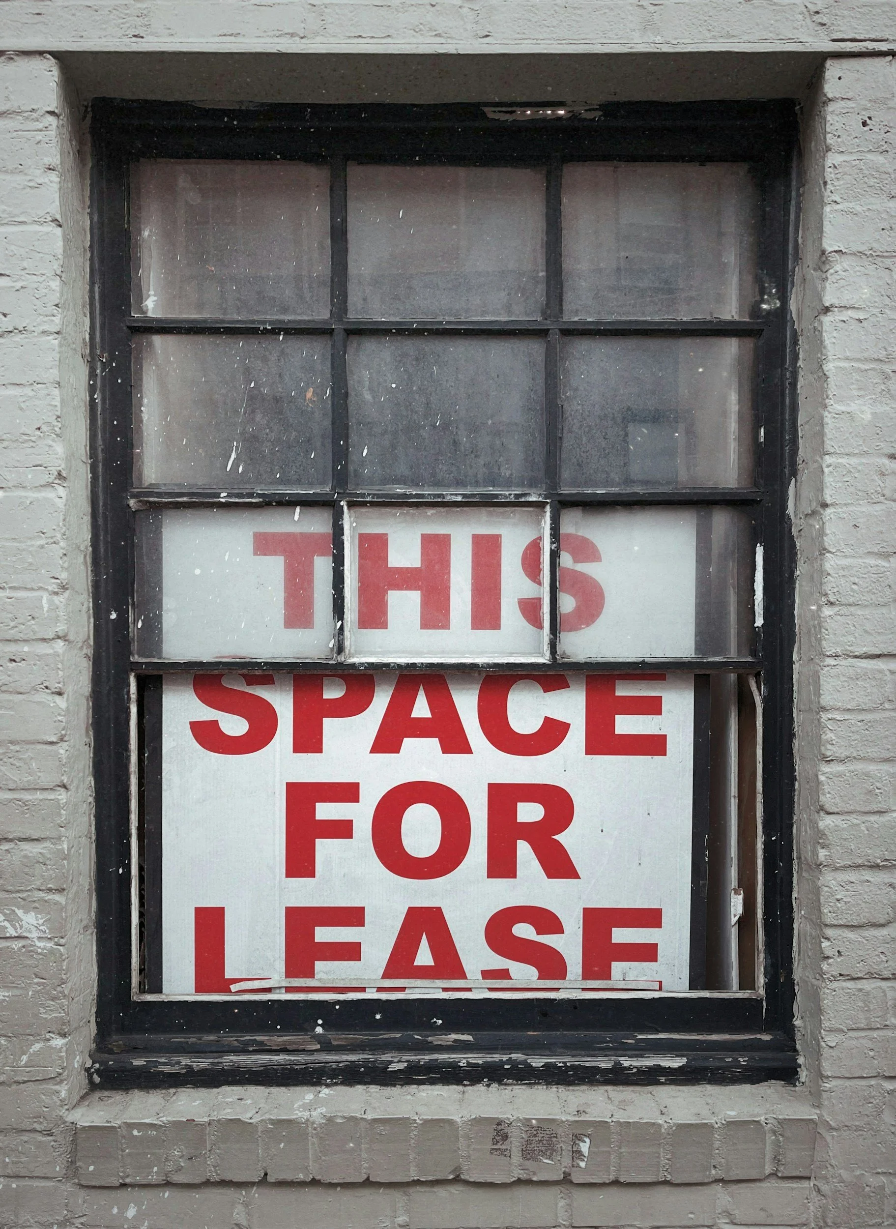 A closed small-town storefront, illustrating the third-place closures tracked by recent research