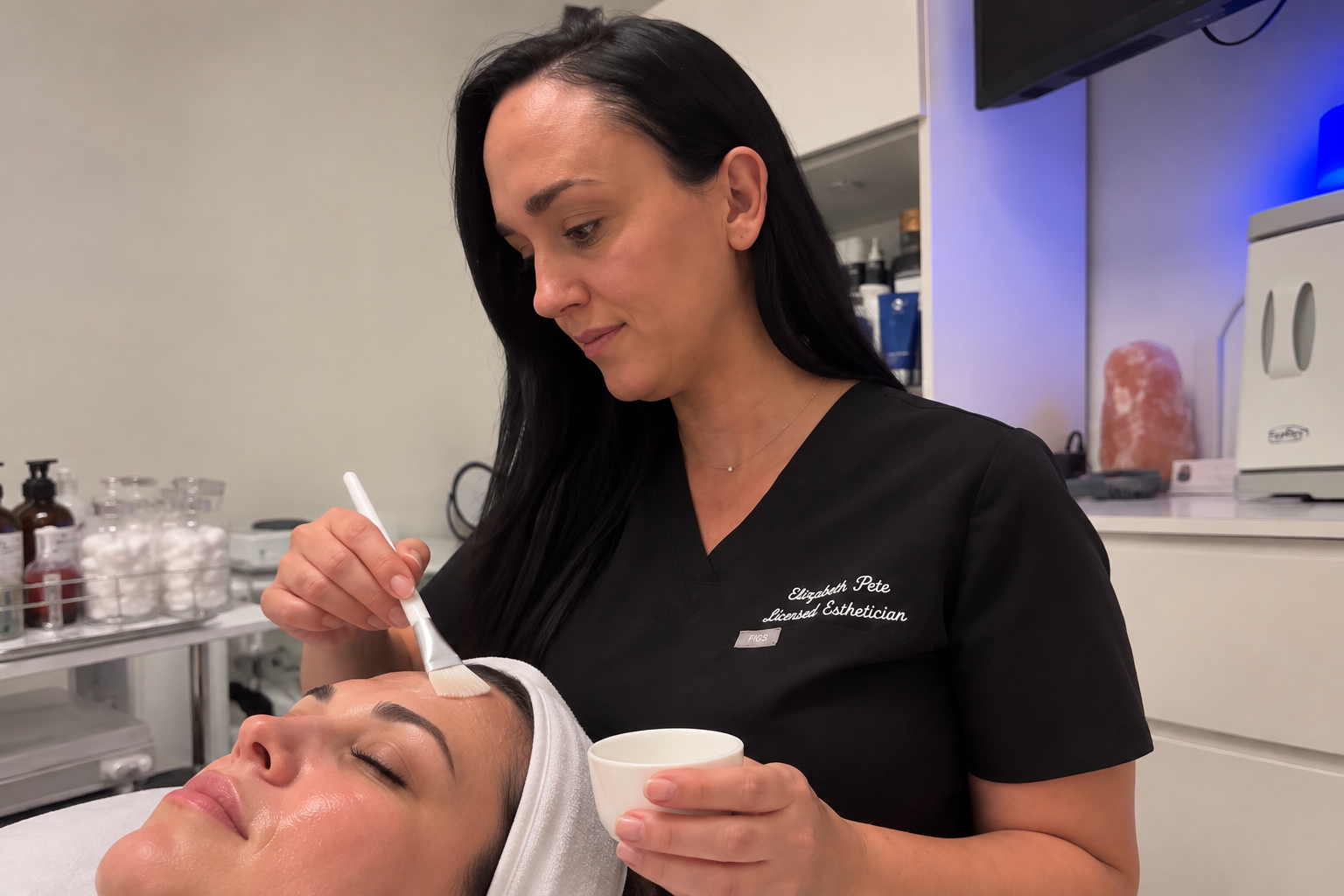 Elizabeth Pete performing a customized facial treatment at Firm Medical Spa in Tulsa