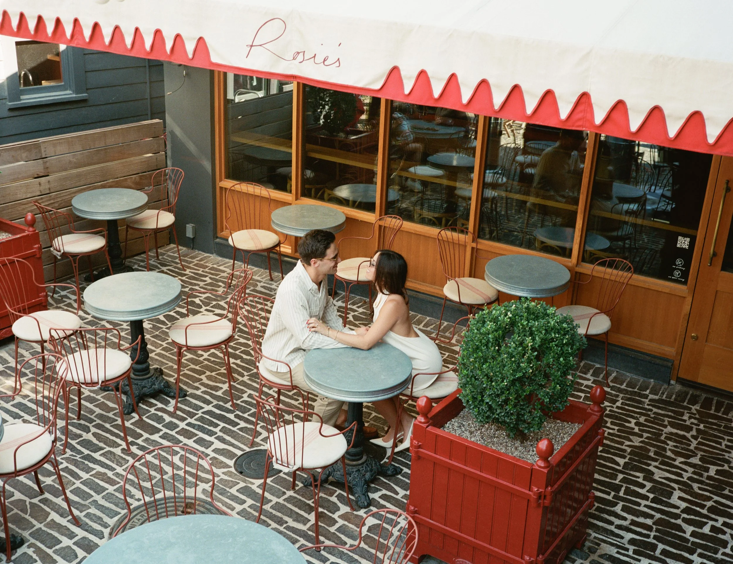 Candid engagement portraits inside Rosie's Wine Bar, Austin TX — analog film photography by Lauren Nicole Photo