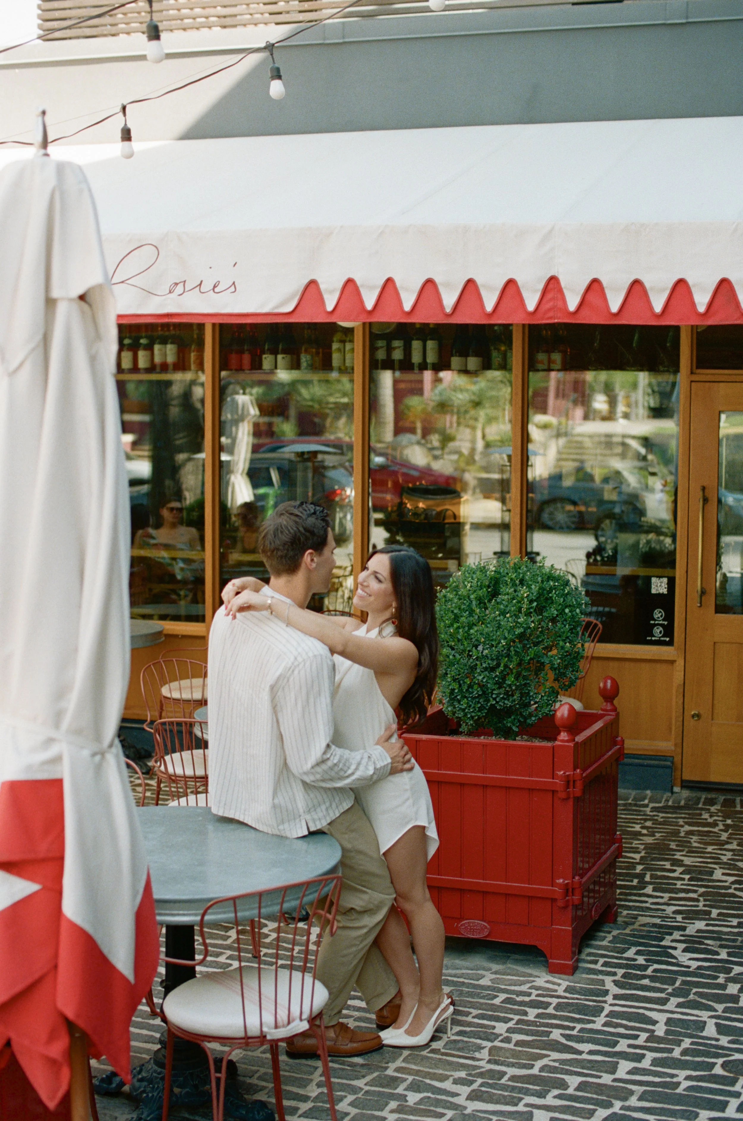 Candid engagement portraits inside Rosie's Wine Bar, Austin TX — analog film photography by Lauren Nicole Photo
