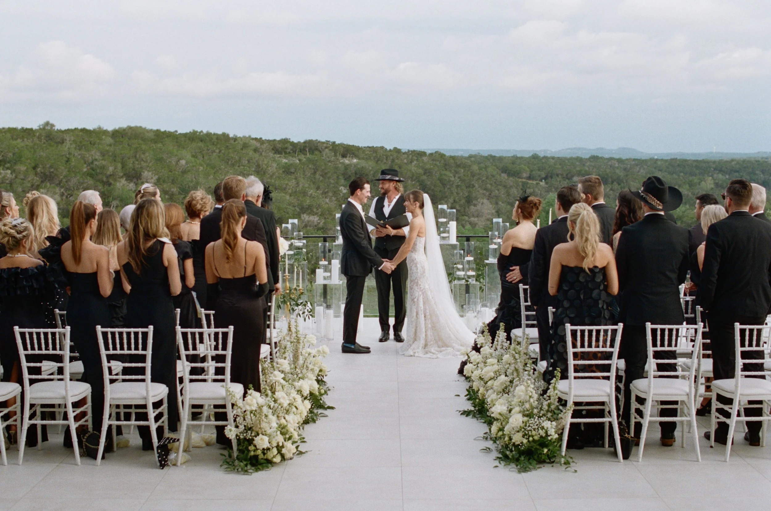 Wedding ceremony at The Videre Estate Wimberley Texas — Kentucky Derby aesthetic, black and white attire, film photography by Lauren Nicole Photo