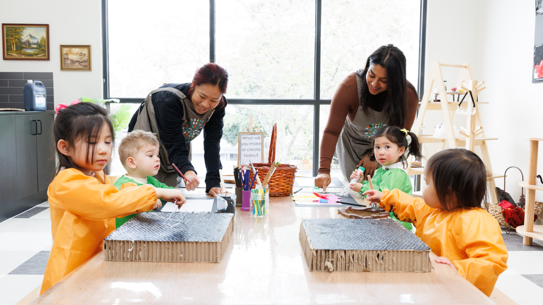 Educators working with children on a hands-on activity at Treetop Early Learning. This scene reflects collaborative learning, nurturing guidance, and the value of interactive experiences in early education.