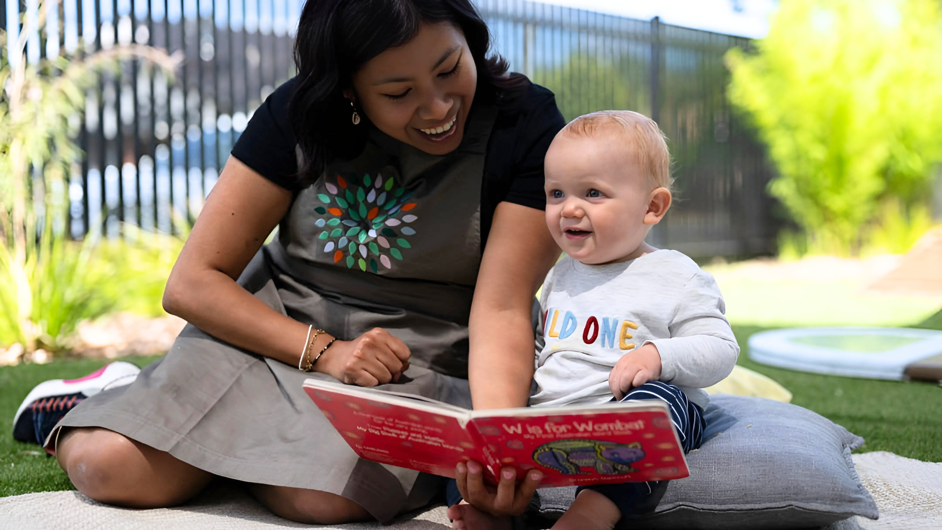 An educator reading a book with a child at Treetop Early Learning. This moment highlights the importance of literacy, language development, and building strong educator-child relationships through shared experiences.