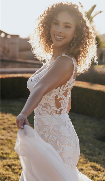 Allure Bridals A1156 fit and flare lace wedding dress with matte lace appliques over Chantilly lace, plunging neckline, and open low back