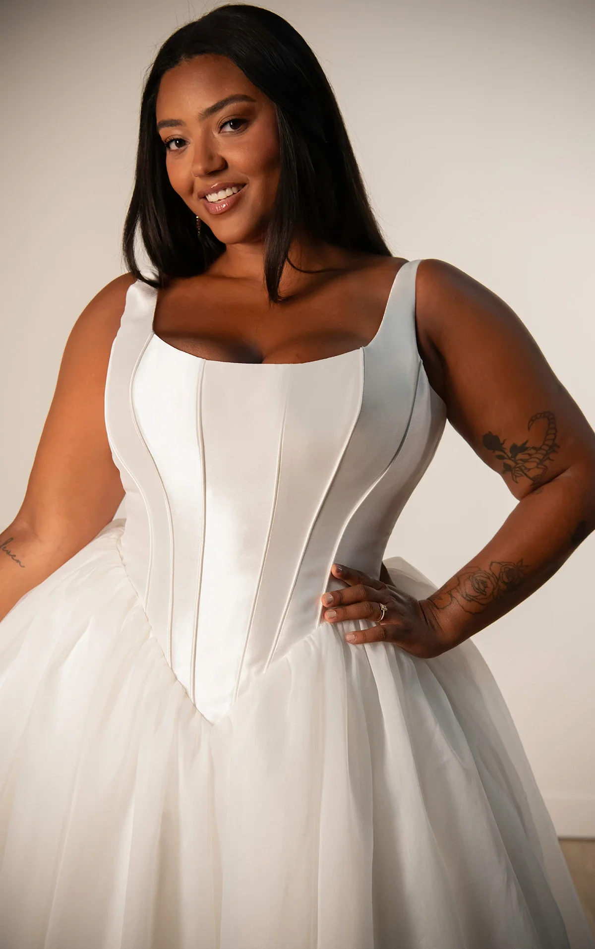 Stella York SY8222+ plus-size ballgown wedding dress with scoop neckline, fitted mikado bodice with basque waistline, and voluminous organza skirt