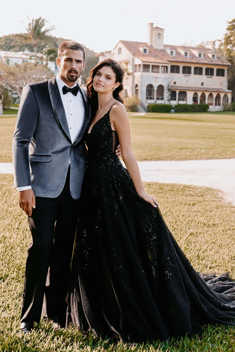 Allure Romance 3400 in black, an A-line wedding gown with V-neckline, spaghetti straps, and floral lace appliqués cascading across the black tulle skirt and train.