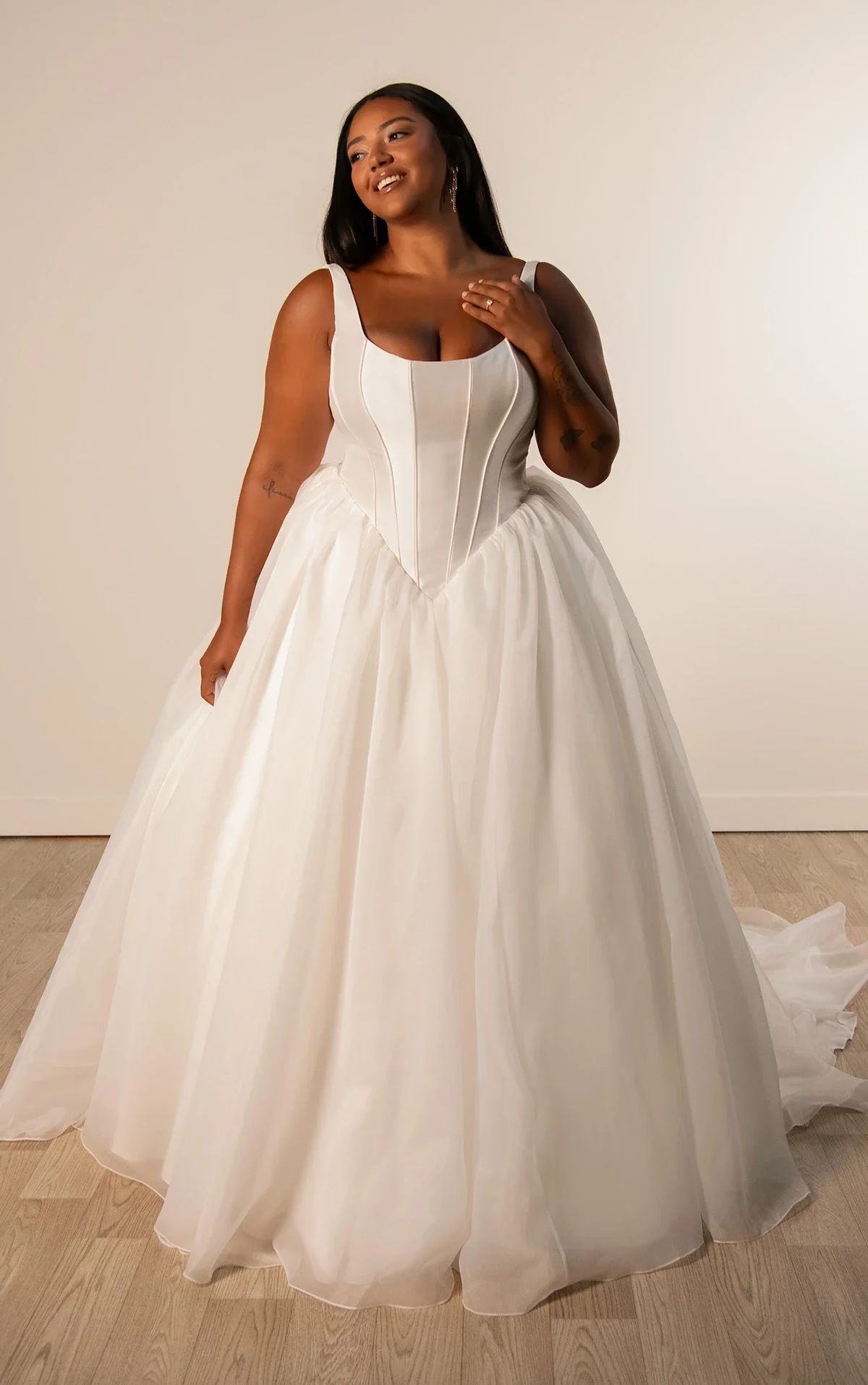 Stella York SY8222+ plus-size ballgown wedding dress with scoop neckline, fitted mikado bodice with basque waistline, and voluminous organza skirt