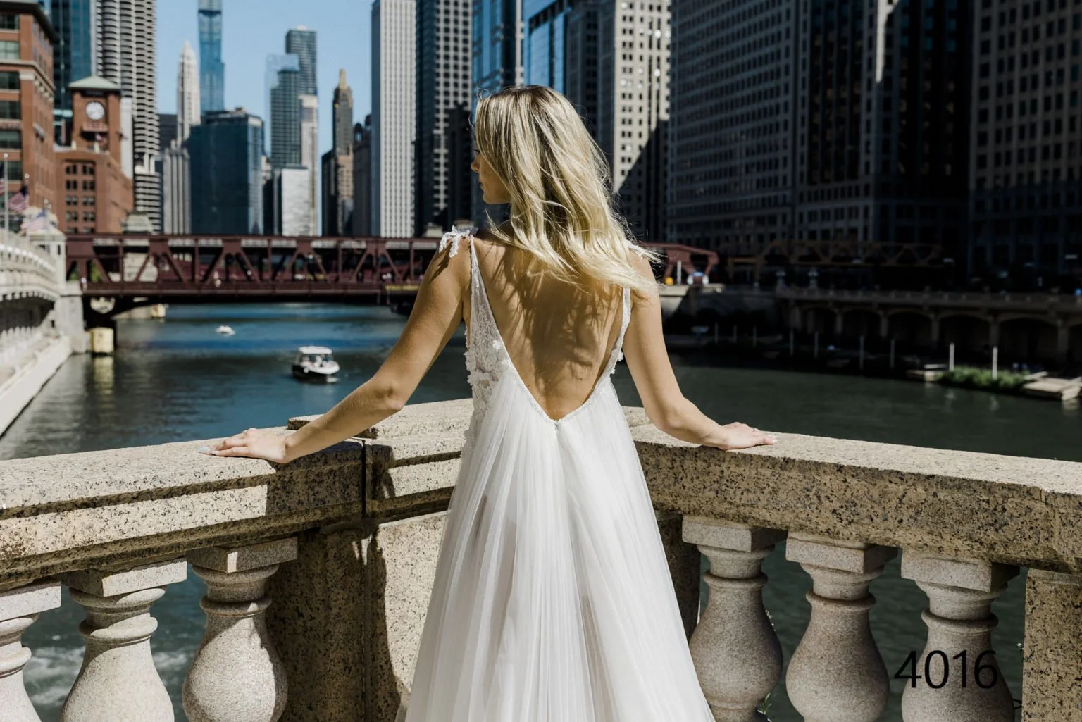 Madam Burcu 4016 A-line wedding dress with floral lace appliqué bodice, plunging V-neckline, soft tulle skirt, thigh-high slit, and low V-back at Olive & Ivory Bride Sacramento.