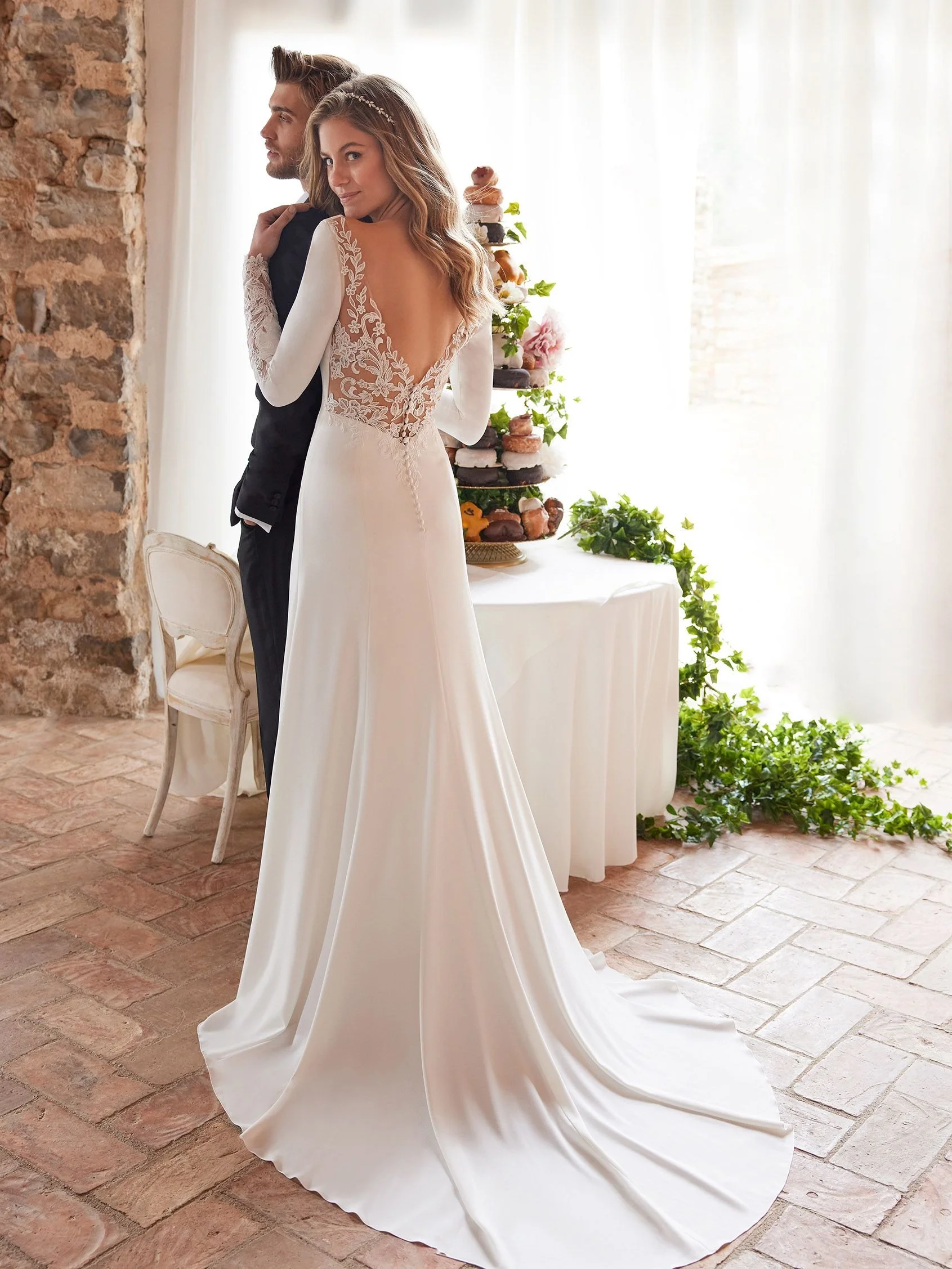 White One Maitasun A-Line wedding gown with V-Neck neckline in Crepe, bridal sample size 10 available at Olive and Ivory Bride Sacramento