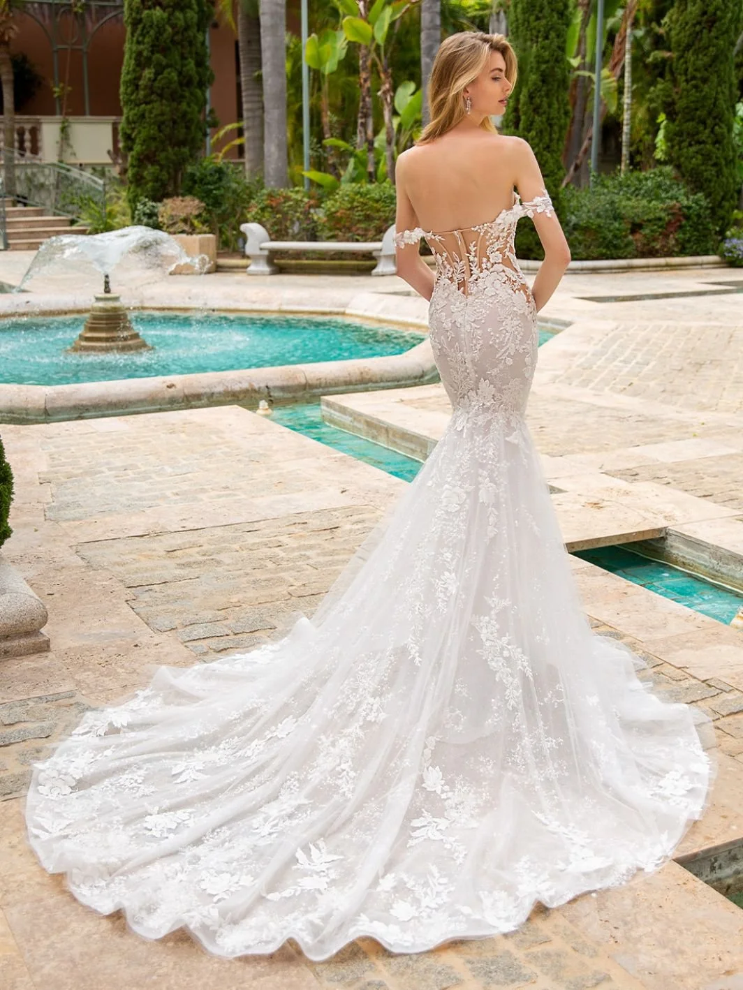 Enzoani Raquel fit and flare mermaid wedding dress with beaded floral lace, deep sweetheart neckline, and illusion corset back
