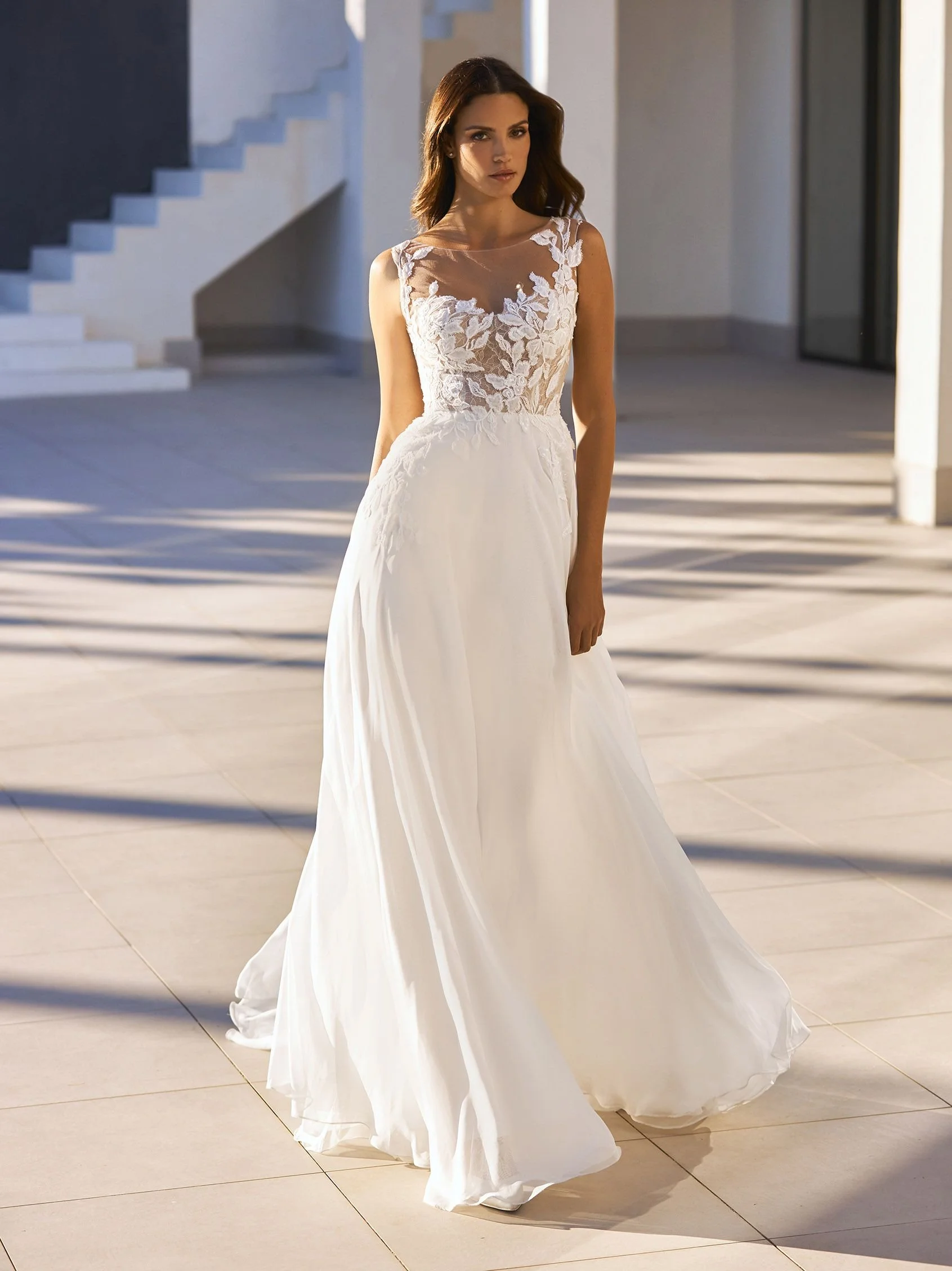 Pronovias Katinka chiffon A-line wedding dress with illusion V-neckline, lace bodice, and removable long sleeves