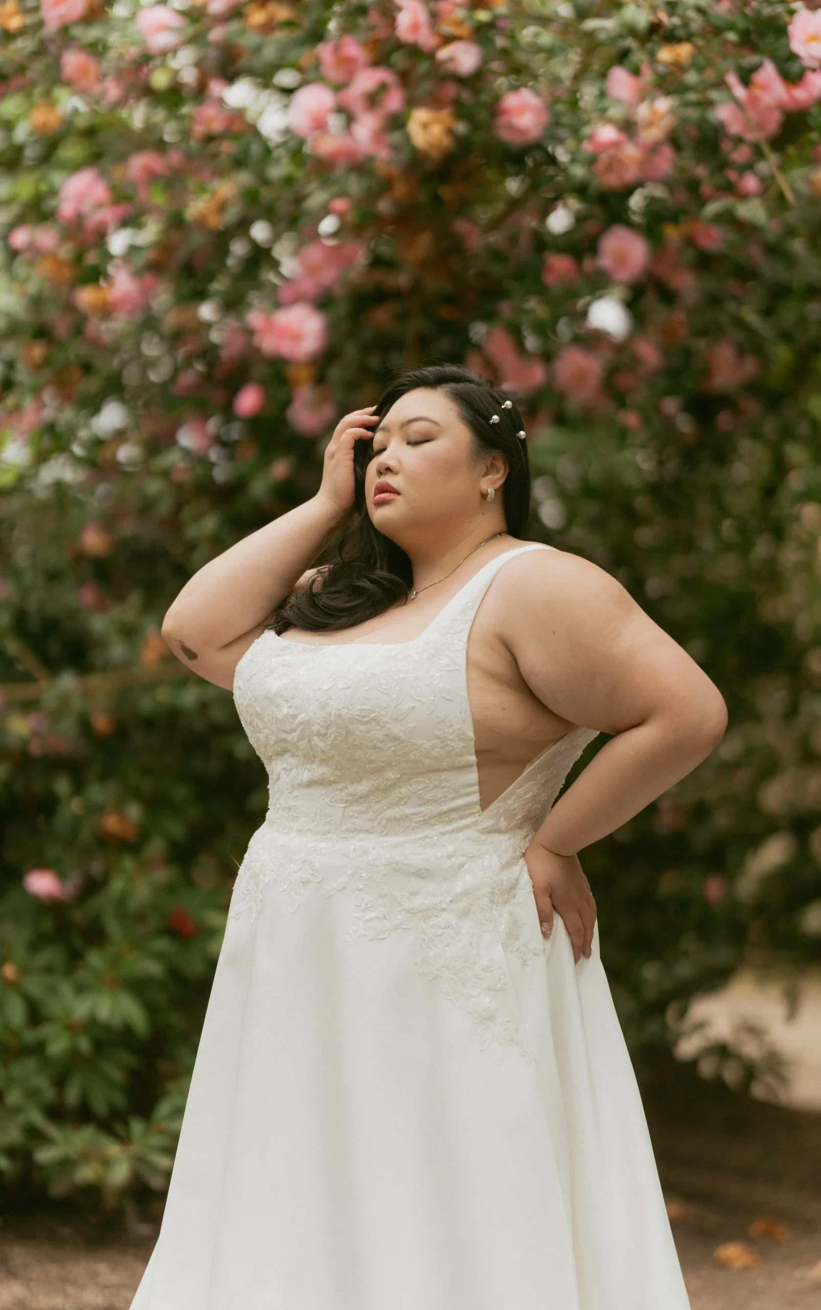 Stella York 7897+ plus-size A-line wedding dress with square neckline, sequin-embellished floral lace bodice, mikado skirt, side cutouts, and hidden pockets
