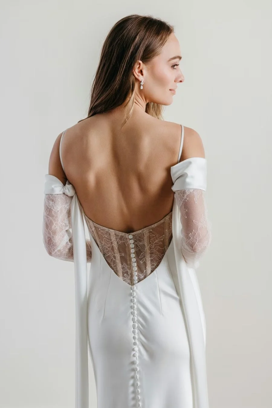 sheath wedding dress in charmeuse and lace with sweetheart neckline, detachable off-the-shoulder sleeves, and removable arm drapes